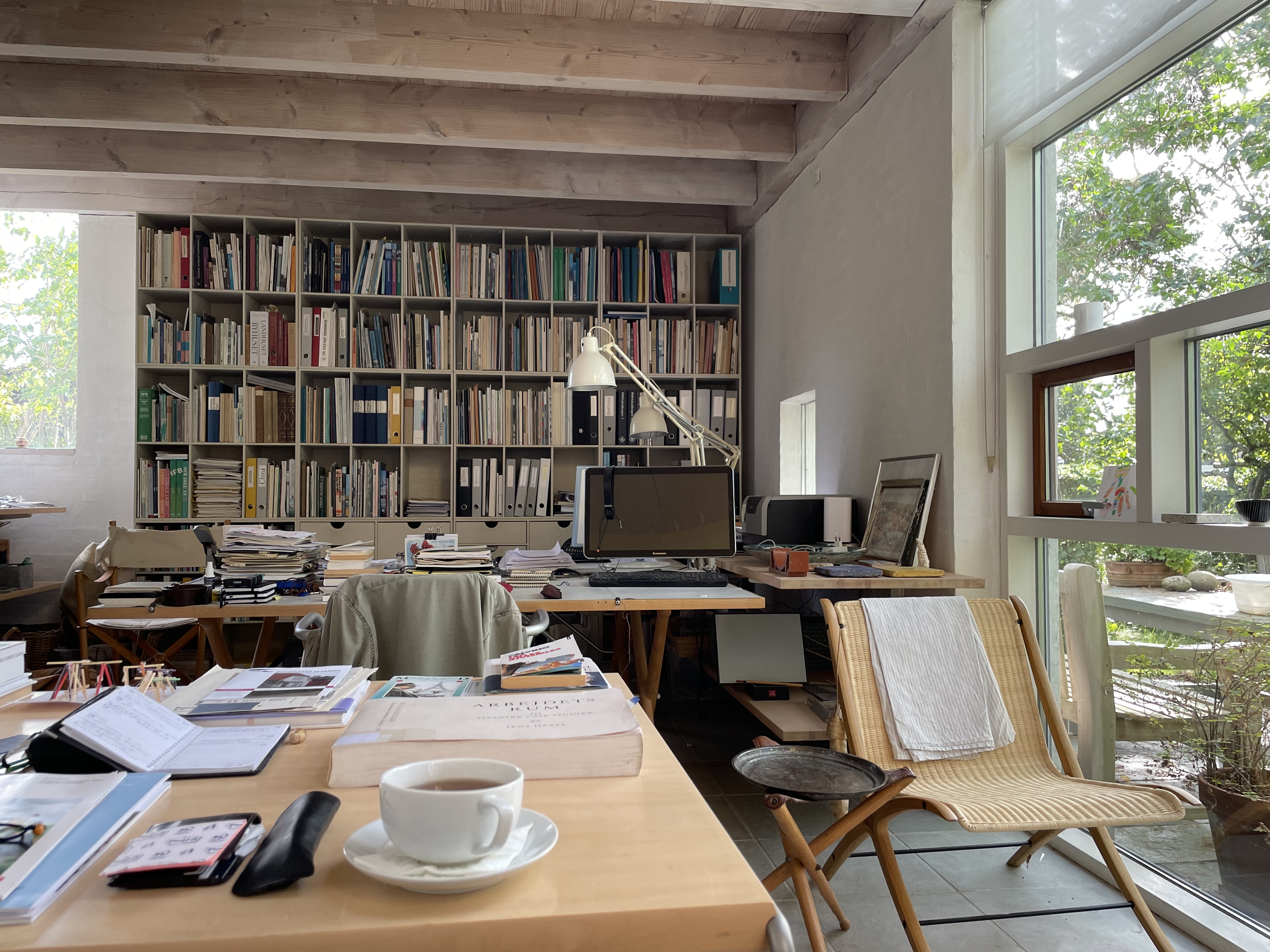 Tegnestuen Raadvad studio at Borgevej — bookshelf, work desks and garden windows
